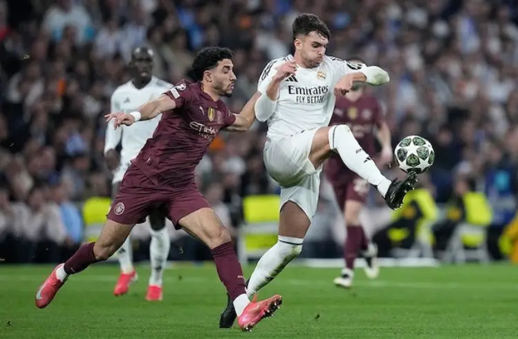 Duel pemain di laga Real Madrid vs Man City, UCL 2024/2025. (c) AP Photo/Bernat Armangue